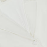 Close-up of the Courtney Cropped Jacket by AMANDA UPRICHARD, featuring an ivory hue, notched collar, two matching fabric-covered buttons, and a cropped silhouette. The inner label reads AMANDA UPRICHARD NEW YORK.