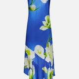 The Gabriella Floral Midi Dress by AMANDA UPRICHARD features thin spaghetti straps, a bold white and green floral print, and an asymmetrical hemline—perfect for making a stylish statement.