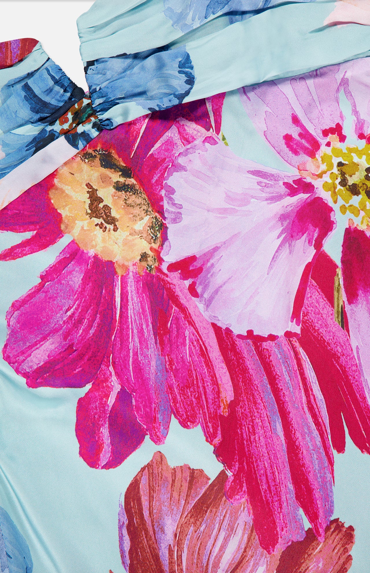 Close-up of the Ira Floral Maxi Dress by AMANDA UPRICHARD, featuring colorful, watercolor-style pink, purple, yellow, and blue flowers on a light blue background—ideal for standout vacation or special occasion looks.