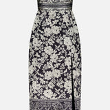The Ivy Jacquard Print Midi Dress by AMANDA UPRICHARD is a fitted, strapless black and cream dress with a floral jacquard print, straight neckline, side slit, and horizontal decorative borders at the waist and hem.