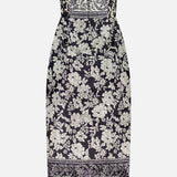 The Ivy Jacquard Print Midi Dress by AMANDA UPRICHARD features a strapless, fitted silhouette in black and cream with an intricate jacquard print, structured bodice, straight hem, and a central front zipper for stylish detail.