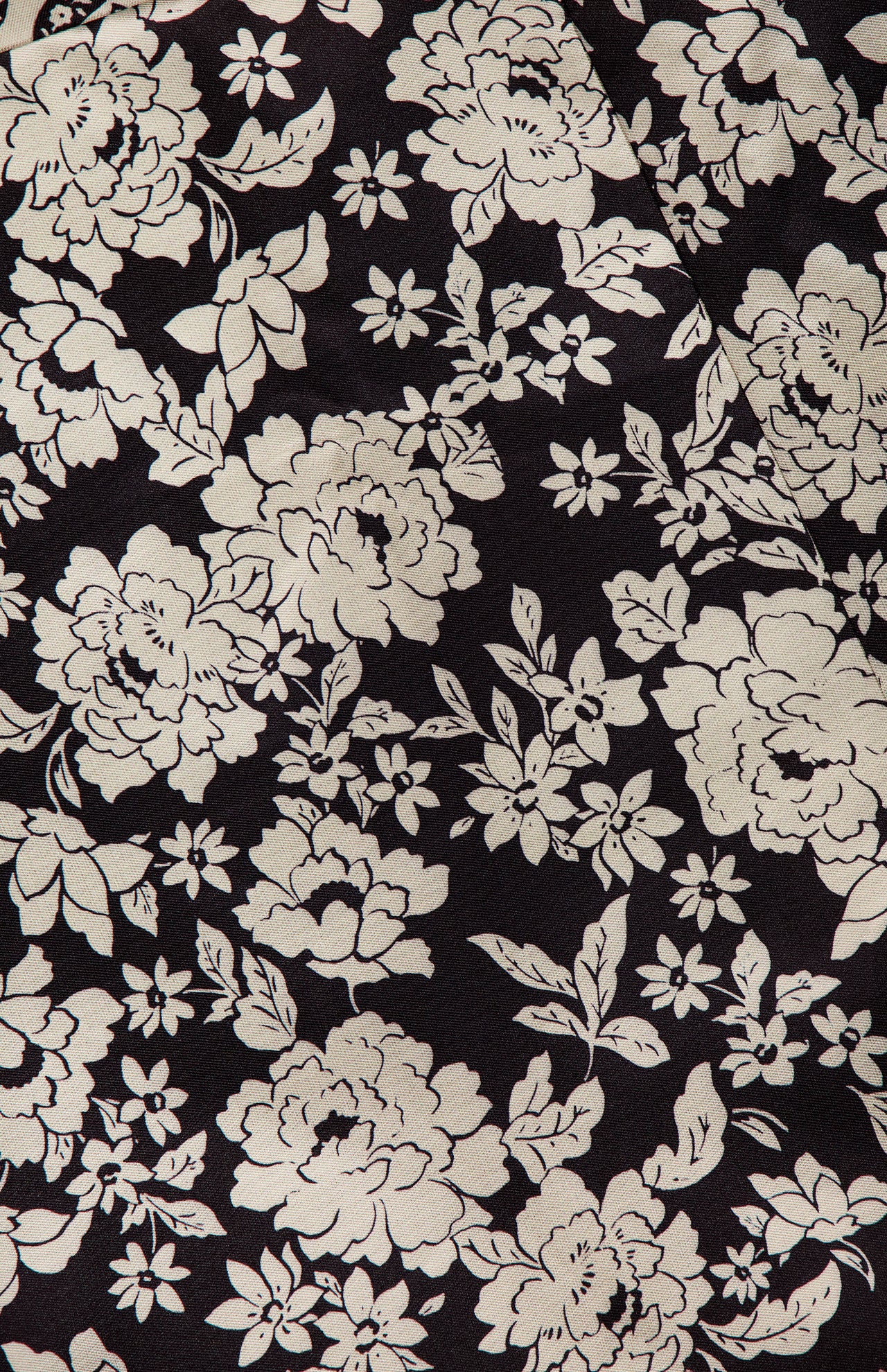 The Ivy Jacquard Print Midi Dress by AMANDA UPRICHARD features a black and cream jacquard design with white florals, large blooms, leaves, and smaller blossoms for a dense, decorative look.
