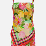 The Keyshia Overlay Mini Dress by AMANDA UPRICHARD is a vibrant sleeveless summer dress with wide shoulder straps, a bold floral print in pink, yellow, orange, and green, and diagonal red, pink, and yellow stripes near the hem—ideal for vacation.