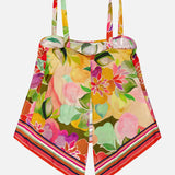 The AMANDA UPRICHARD Keyshia Back Vent Top is a vibrant, vacation-ready style with thin straps, a colorful floral pattern, and pointed asymmetrical hem—finished with striped edges for a chic tropical vibe.
