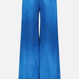 The Kordell Satin Pants by AMANDA UPRICHARD feature a wide-leg, high-waisted teal design with an elastic waistband and two back welt pockets, shown from the back against a white background—ideal for effortless resort style.