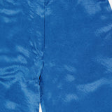 Close-up of AMANDA UPRICHARD Kordell Satin Pants in teal, highlighting the waistband and textured, slightly wrinkled satin—ideal for chic resort wear.