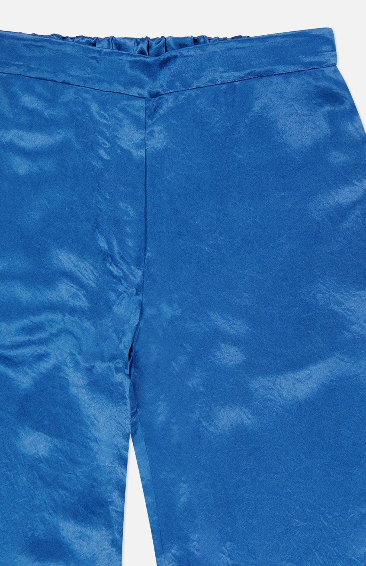 Close-up of AMANDA UPRICHARD Kordell Satin Pants in teal, highlighting the waistband and textured, slightly wrinkled satin—ideal for chic resort wear.