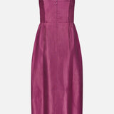 The Lyra Midi Dress by AMANDA UPRICHARD features a sleeveless, knee-length magenta design with thin straps, a fitted bodice, and a slightly flared skirt, shown against a plain white background.