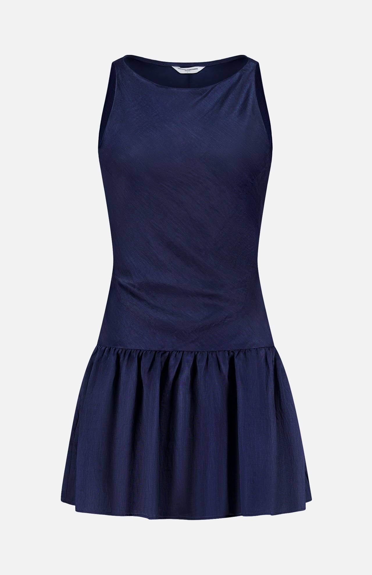 The AMANDA UPRICHARD Margo Drop Waist Skirt Dress is a sleeveless navy linen organza mini dress with a fitted bodice and dropped waist, featuring a gathered flared skirt. Shown against a plain white background.