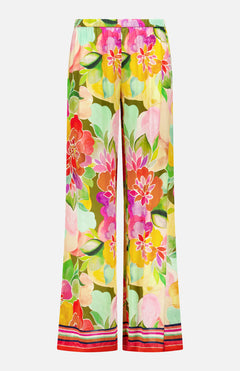 The Mariko Wide Leg Floral Pants by AMANDA UPRICHARD feature a vibrant multicolored floral print and relaxed fit, finished with red, white, and black striped trim at the hem.