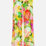 The Mariko Wide Leg Floral Pants by AMANDA UPRICHARD feature a relaxed wide-leg silhouette with a vibrant green, yellow, red, pink, and orange floral print and bold red, pink, and black horizontal stripes at the hem.