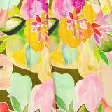 Close-up of the Mariko Wide Leg Floral Pants by AMANDA UPRICHARD, showcasing a vibrant watercolor floral print with large yellow, pink, green, and red flowers and an elastic waistband for a relaxed wide-leg fit.