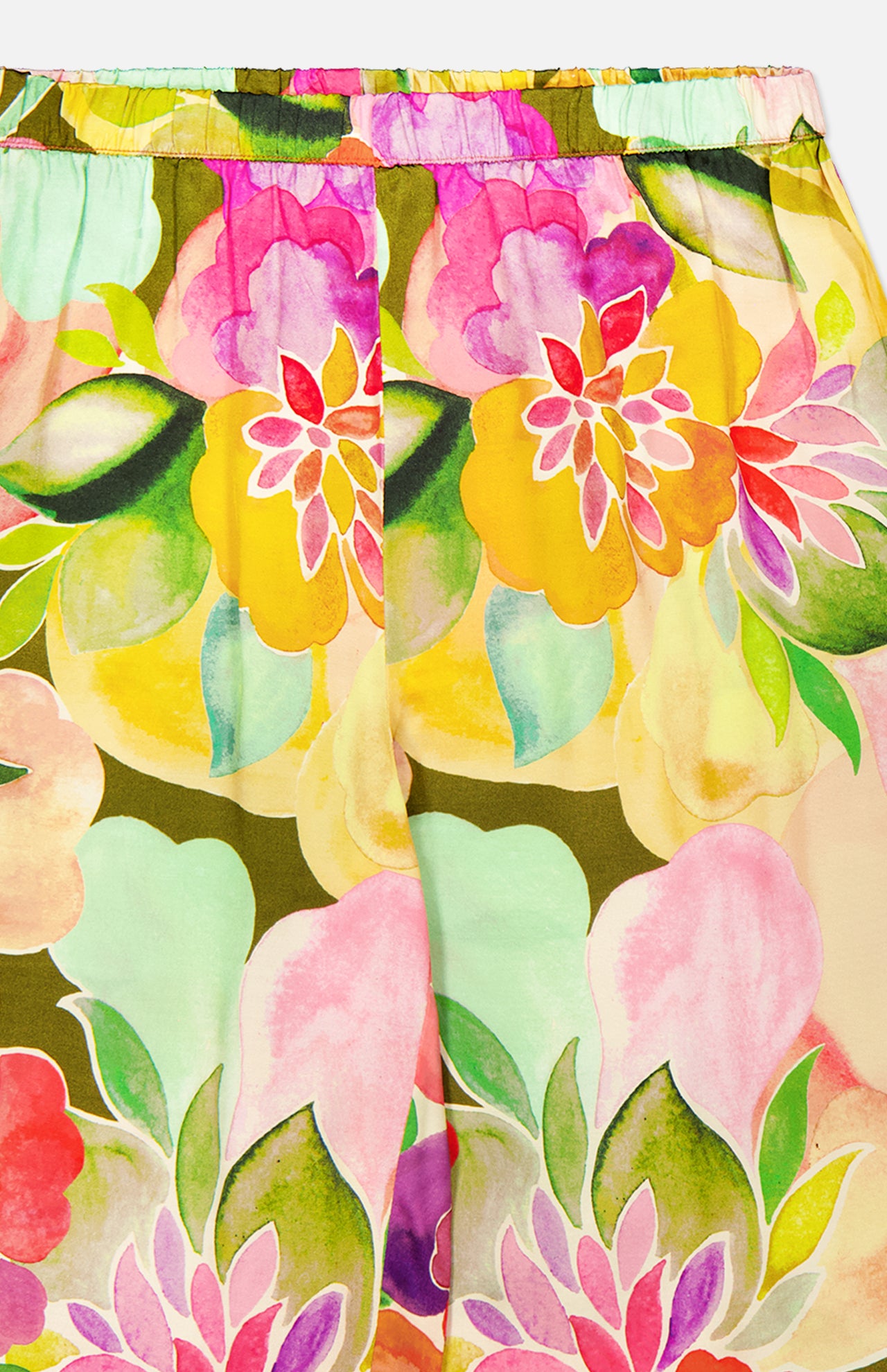Close-up of the Mariko Wide Leg Floral Pants by AMANDA UPRICHARD, showcasing a vibrant watercolor floral print with large yellow, pink, green, and red flowers and an elastic waistband for a relaxed wide-leg fit.