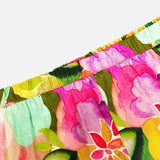 Close-up of the Mariko Wide Leg Floral Pants by AMANDA UPRICHARD, showcasing a vibrant floral print in pink, yellow, green, and red with an elastic gathered top—ideal for a relaxed wide-leg silhouette.