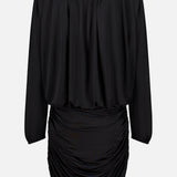 The Martha Ruched Mini Dress by AMANDA UPRICHARD is a black long-sleeve dress featuring a loose, draped top and a fitted, ruched bottom—evoking the chic silhouette of a sexy LBD—shown from the back against a plain white background.