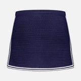 The AMANDA UPRICHARD Monique Knit Mini Skort is navy with a fitted silhouette and white trim on the sides and hem, shown against a plain white background.