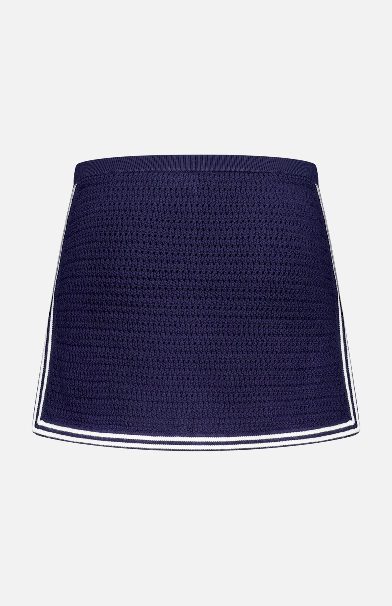The AMANDA UPRICHARD Monique Knit Mini Skort is navy with a fitted silhouette and white trim on the sides and hem, shown against a plain white background.