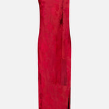 The Sonya Fringed Maxi Dress by AMANDA UPRICHARD is a sleeveless, dark red satin floral jacquard dress with a subtle pattern, high neckline, and a matching long scarf draped over one shoulder. This elegant maxi dress features a side slit and a fitted, ankle-length silhouette.