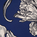 Black and white sketch-style floral illustrations with bold outlines evoke the elegance of the ANDRÉS OTÁLORA Amani Maxi Halter Neck Dress, featuring partially visible flowers and leaves on a deep blue background for an abstract, artistic look.