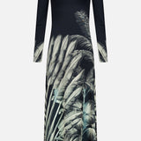 The Donde Empieza Embellished Maxi Dress by ANDRÉS OTÁLORA is a long-sleeved black dress with a round neckline, beaded keyhole detail, and a botanical palm print featuring grey and green tropical leaves on the lower half and sleeves.
