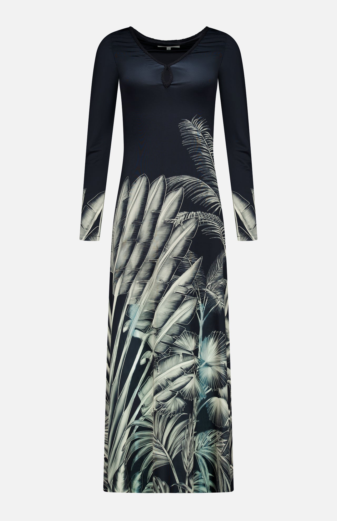 The Donde Empieza Embellished Maxi Dress by ANDRÉS OTÁLORA is a long-sleeved black dress with a round neckline, beaded keyhole detail, and a botanical palm print featuring grey and green tropical leaves on the lower half and sleeves.