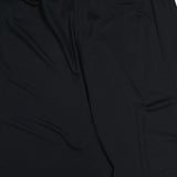 Close-up of En Calma Palm Print Pants by ANDRÉS OTÁLORA, featuring an elastic waistband and smooth fabric, shown against a white background.