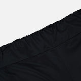 Close-up of the elastic waistband on the En Calma Palm Print Pants by ANDRÉS OTÁLORA, set against a plain white background.