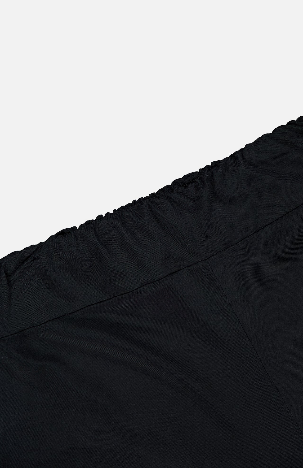 Close-up of the elastic waistband on the En Calma Palm Print Pants by ANDRÉS OTÁLORA, set against a plain white background.