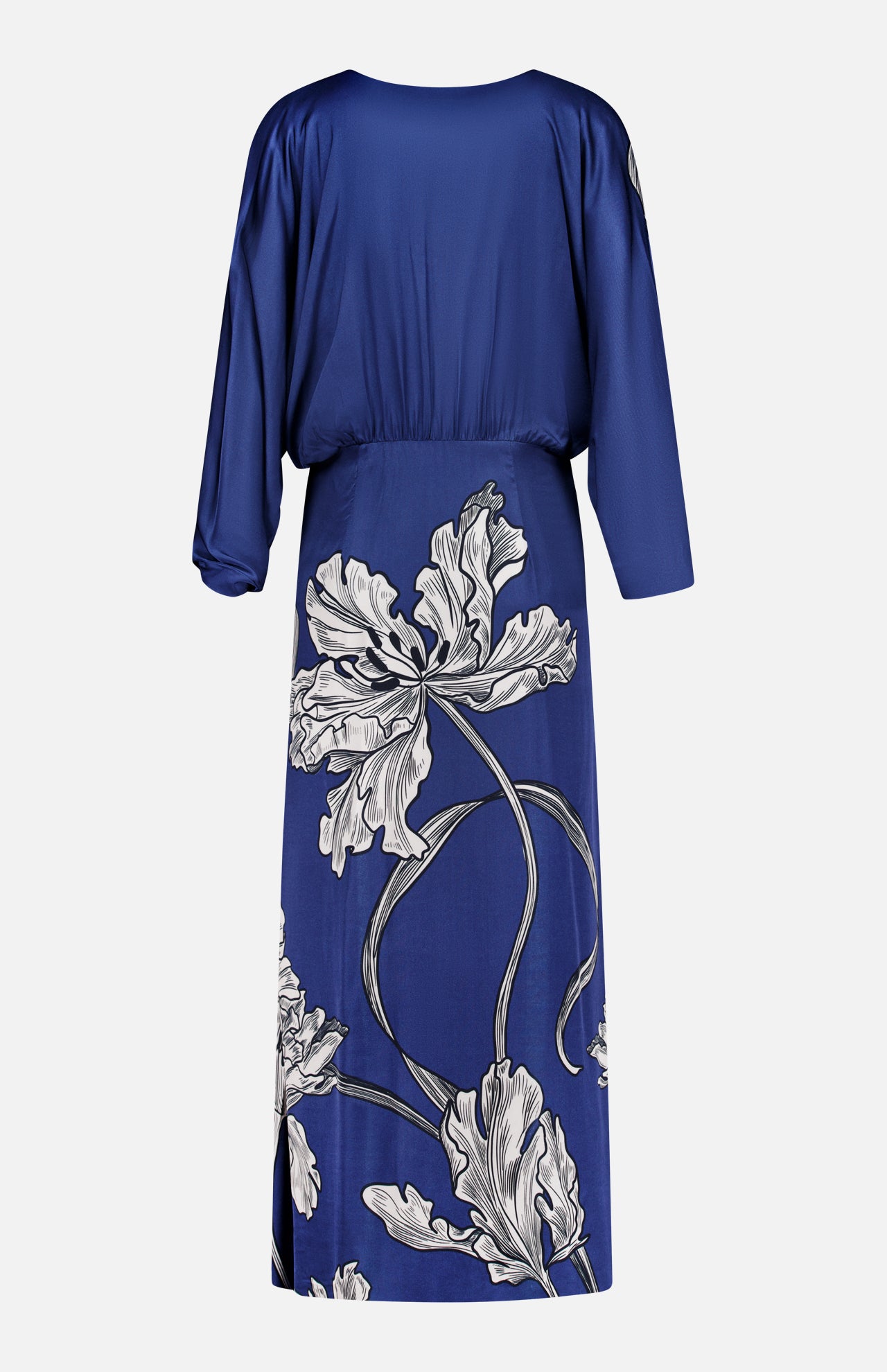 The Olanna Twist Front Maxi Dress by ANDRÉS OTÁLORA features long sleeves, a cinched waist, navy fabric, and white floral patterns on the lower half for a Mediterranean-inspired look.
