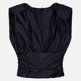 The ANDRÉS OTÁLORA Tan Lejos Top is a sleeveless black blouse with a wide neckline and gathered waist, shown flat on a white background.
