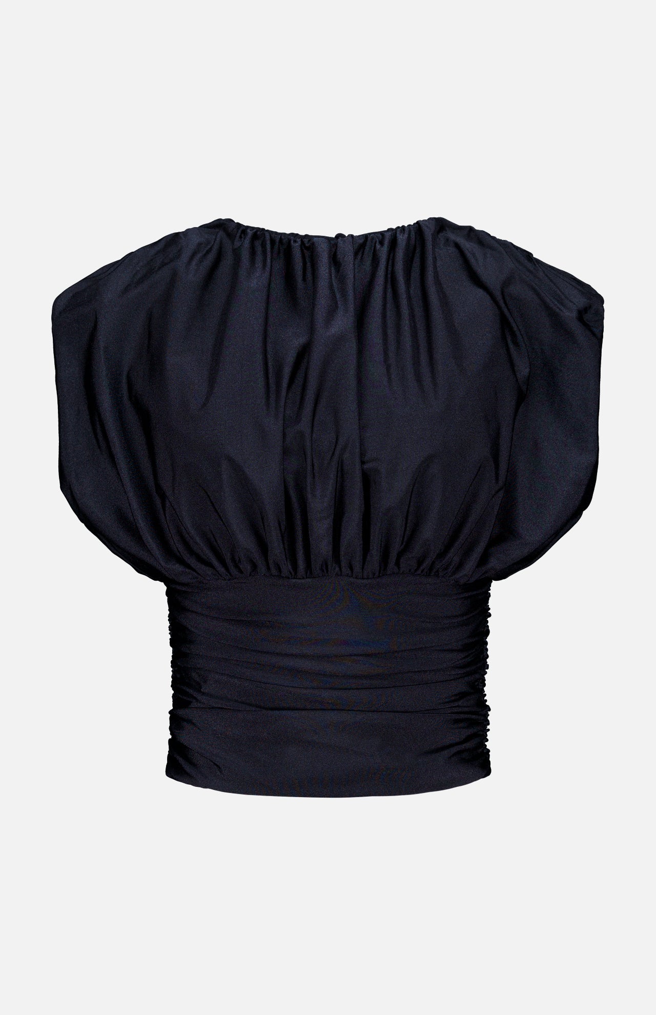 The Tan Lejos Top by ANDRÉS OTÁLORA is a sculptural black short-sleeved blouse with ruching, a wide gathered neckline, and fitted pleated waistband—an elegant going-out top shown on a plain white background.
