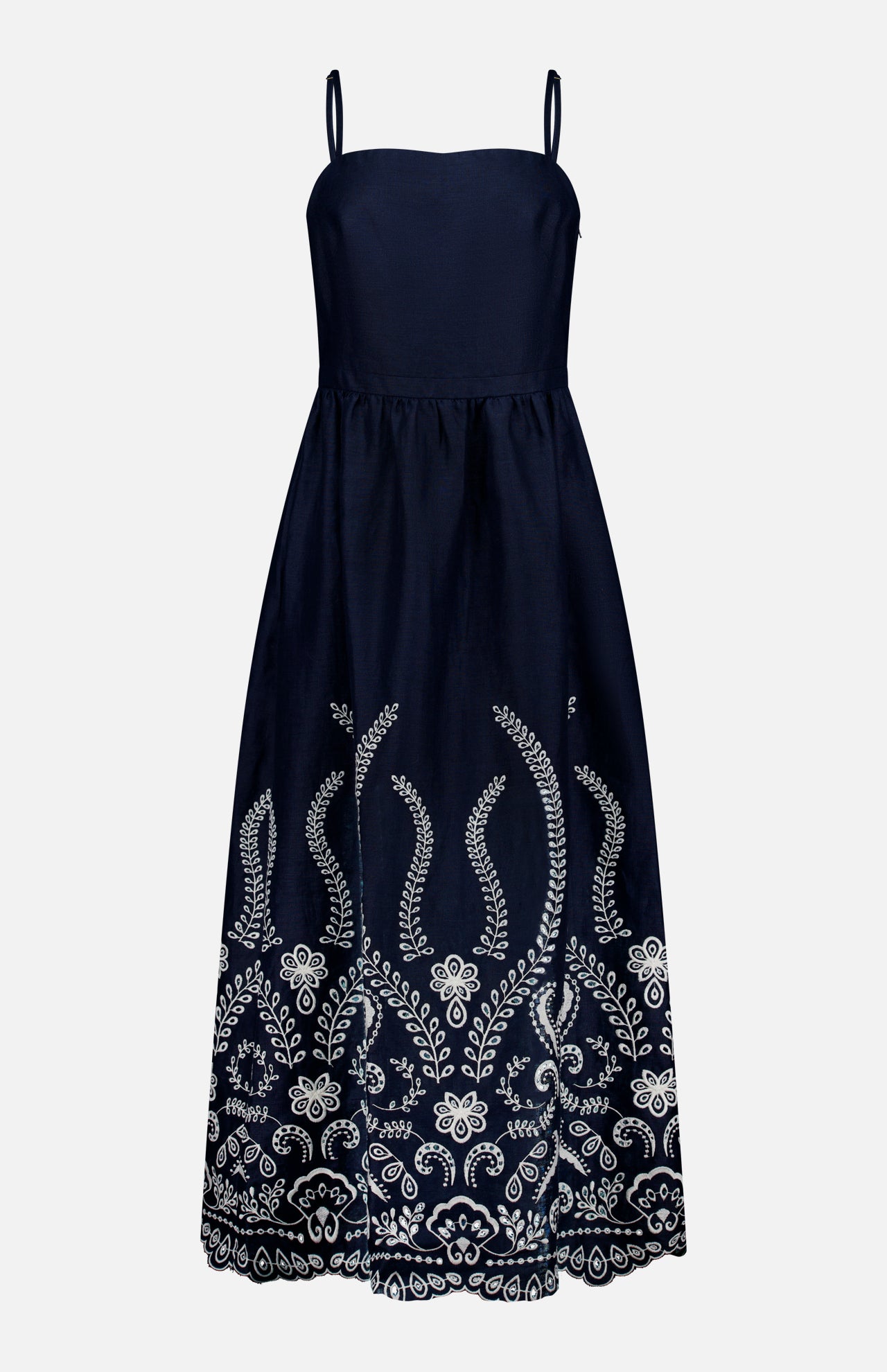 The ANDRÉS OTÁLORA Y Tu Voz Eyelet Dress is a navy blue linen piece with thin straps, a fitted bodice, white floral embroidery on the lower half, and a scalloped hem.
