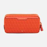 Anya Hindmarch Beach Things Pouch, an orange rectangular zippered travel pouch with a repeating pattern and the word SUNCREAMS embossed on a leather tab.