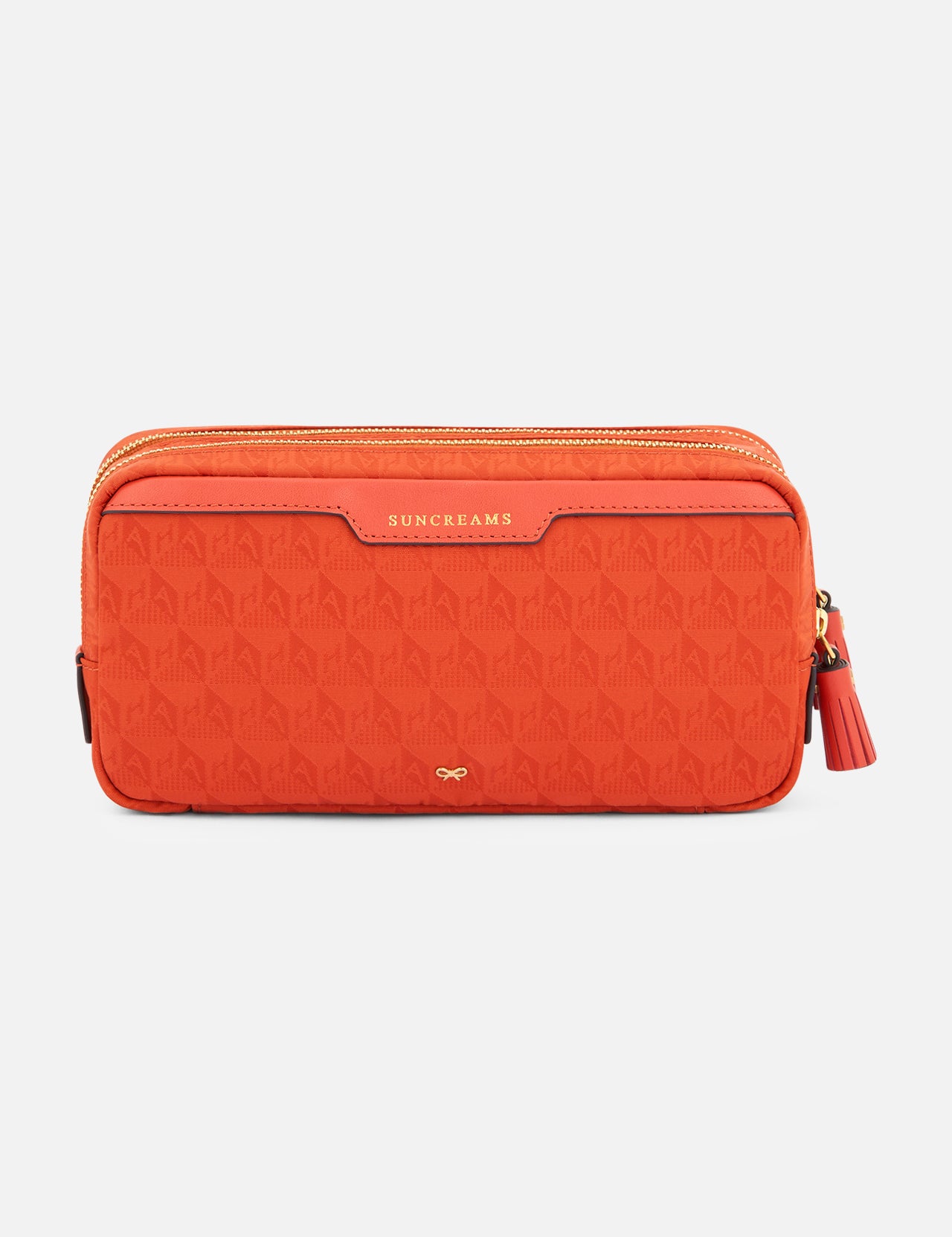 Anya Hindmarch Beach Things Pouch, an orange rectangular zippered travel pouch with a repeating pattern and the word SUNCREAMS embossed on a leather tab.