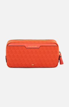 Anya Hindmarch Beach Things Pouch, an orange rectangular zippered travel pouch with a repeating pattern and the word SUNCREAMS embossed on a leather tab.