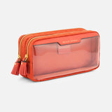Anya Hindmarch Beach Things Pouch, a rectangular orange travel pouch featuring a clear front panel and two tassel-ended zipper pulls.