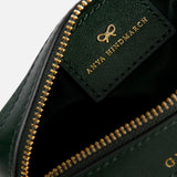 A dark green jacquard nylon Anya Hindmarch Logo Girlie Stuff pouch featuring a gold metal zipper and an interior leather tag embossed with a bow logo and the brand name.