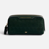 Dark green rectangular Anya Hindmarch Logo Girlie Stuff Pouch in jacquard nylon, featuring a zippered closure, GIRLIE STUFF embossed in gold on the top trim, and a small gold bow logo at the bottom.