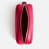 Open, fuchsia-colored jacquard nylon rectangular Anya Hindmarch Logo Girlie Stuff Pouch with a gold zipper and the words GIRLIE STUFF embossed on the side.
