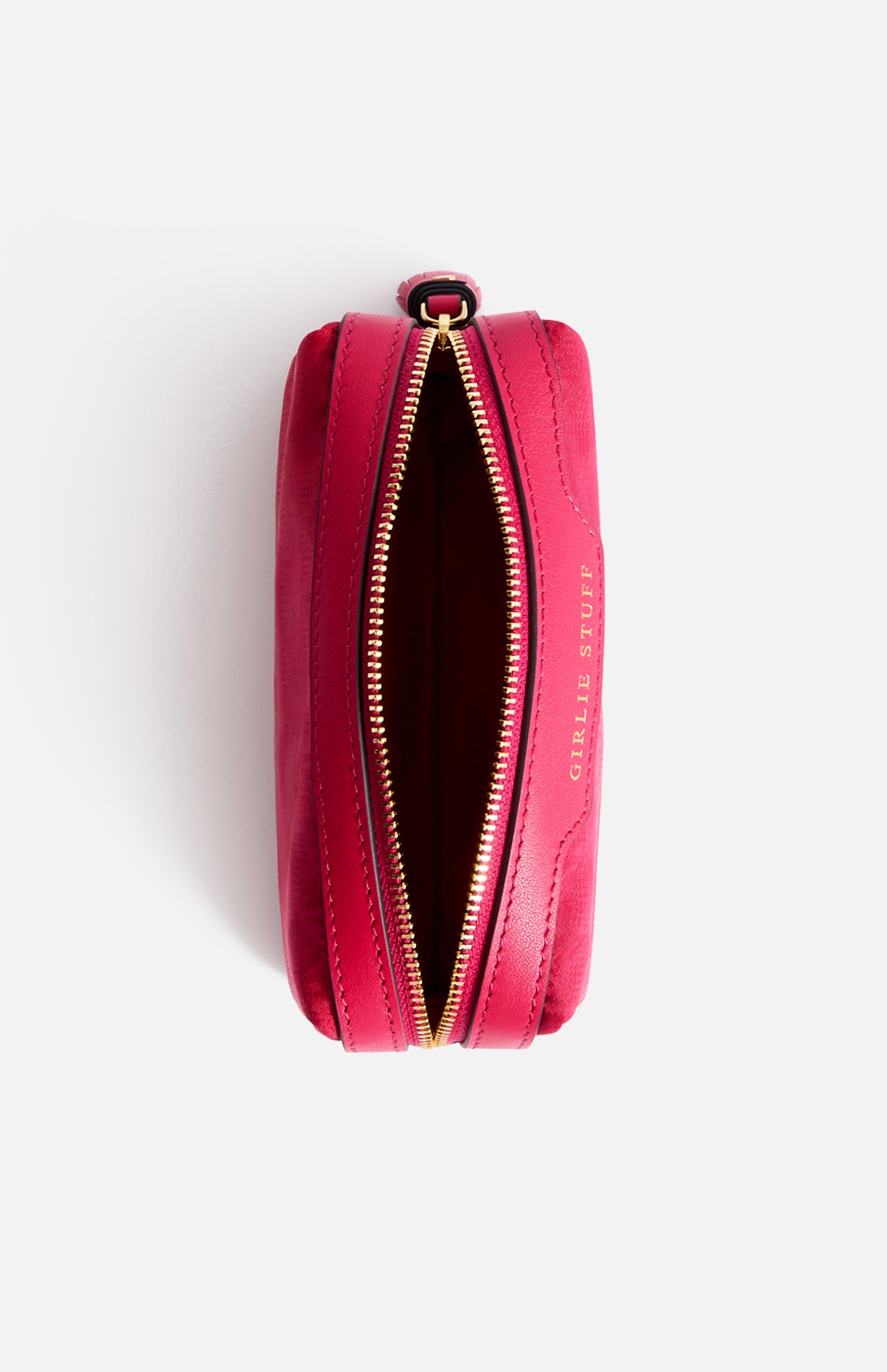 Open, fuchsia-colored jacquard nylon rectangular Anya Hindmarch Logo Girlie Stuff Pouch with a gold zipper and the words GIRLIE STUFF embossed on the side.