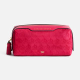 Anya Hindmarch Logo Girlie Stuff Pouch in rectangular magenta jacquard nylon, featuring a tassel zipper pull, embossed text, and a small gold bow emblem.