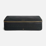 Anya Hindmarch Logo Hair Kit Travel Pouch, a black rectangular case with a wrap-around gold zipper and the text HAIR KIT centered on the front.