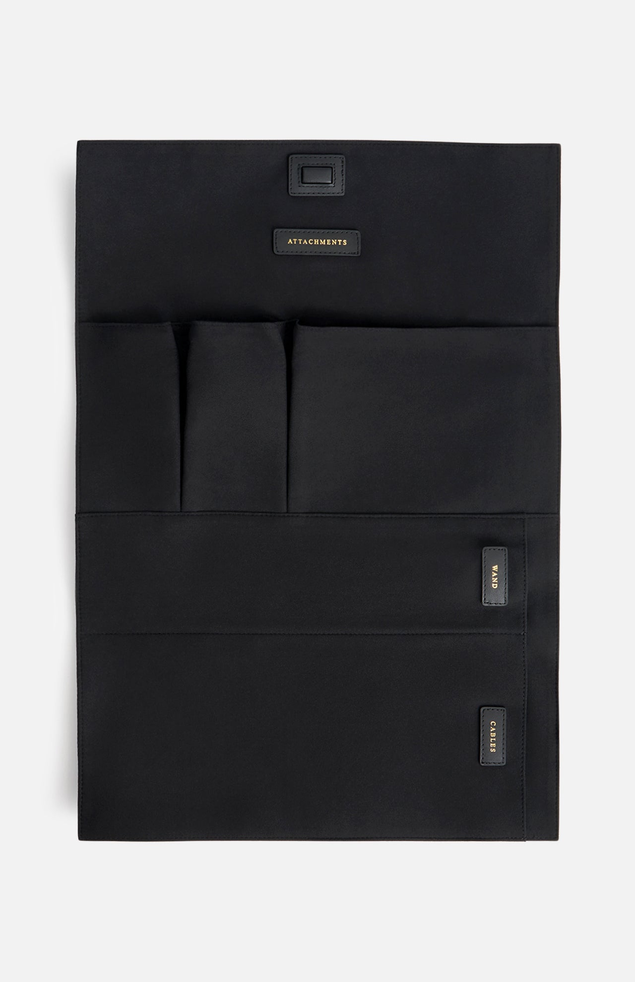 Black Anya Hindmarch Logo Hair Kit Travel Pouch with multiple interior pockets labeled Attachments, Wand, and Cables.