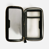 Anya Hindmarch Logo In-Flight Case, an open rectangular travel accessory with a gold-tone zipper, clear sides, internal dividers, and a secure zip closure.