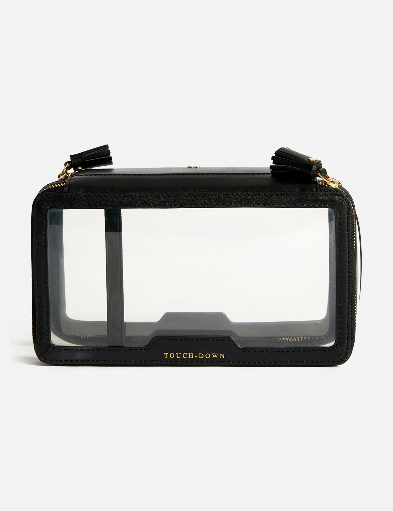 Anya Hindmarch Logo In-Flight Case, a black rectangular travel accessory with clear front and back panels, gold-tone hardware, tassel zipper pulls, and the word TOUCH-DOWN embossed at the bottom of the zip closure.