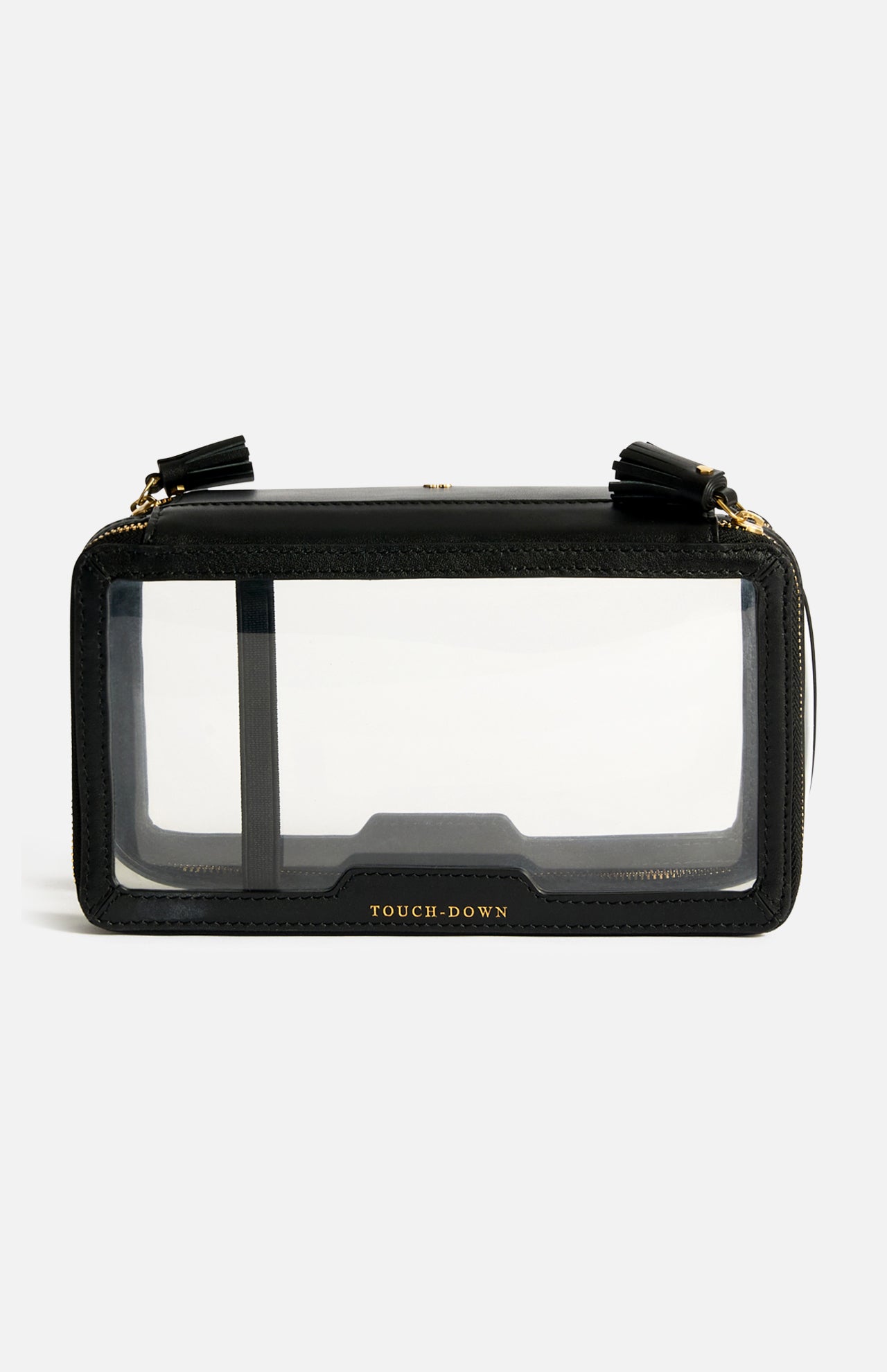 Anya Hindmarch Logo In-Flight Case, a black rectangular travel accessory with clear front and back panels, gold-tone hardware, tassel zipper pulls, and the word TOUCH-DOWN embossed at the bottom of the zip closure.
