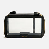 Anya Hindmarch Logo In-Flight Case in black rectangular nylon with a clear front panel, gold zip closure, and TAKE-OFF embossed in gold near the bottom.