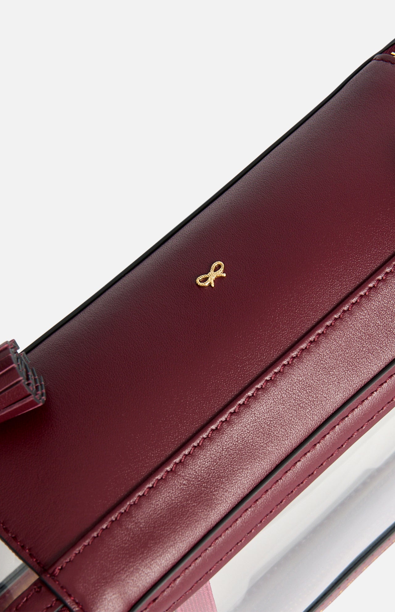 Burgundy Logo In-Flight Case featuring a small gold bow emblem.