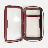 Open, rectangular burgundy Anya Hindmarch Logo In-Flight Case with transparent plastic panels and a gold-tone zipper.