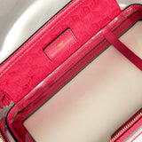 Anya Hindmarch Logo In-Flight Case: an open rectangular clear case with pink trim, gold zippers, and a patterned pink interior lining featuring a central gold logo plaque.